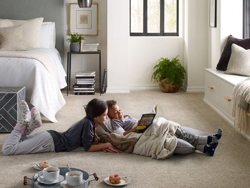 Two kids reading on bedroom carpet from B & B Floor Co in Springfield, VA